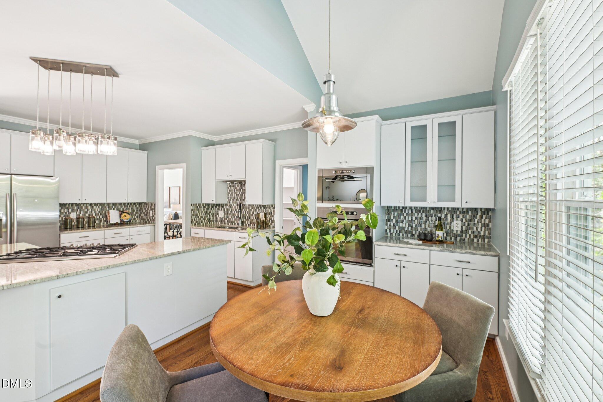 3008 Walton Heath Court Raleigh, NC 27612 - Photo 19 of 57 a kitchen with a table and chairs