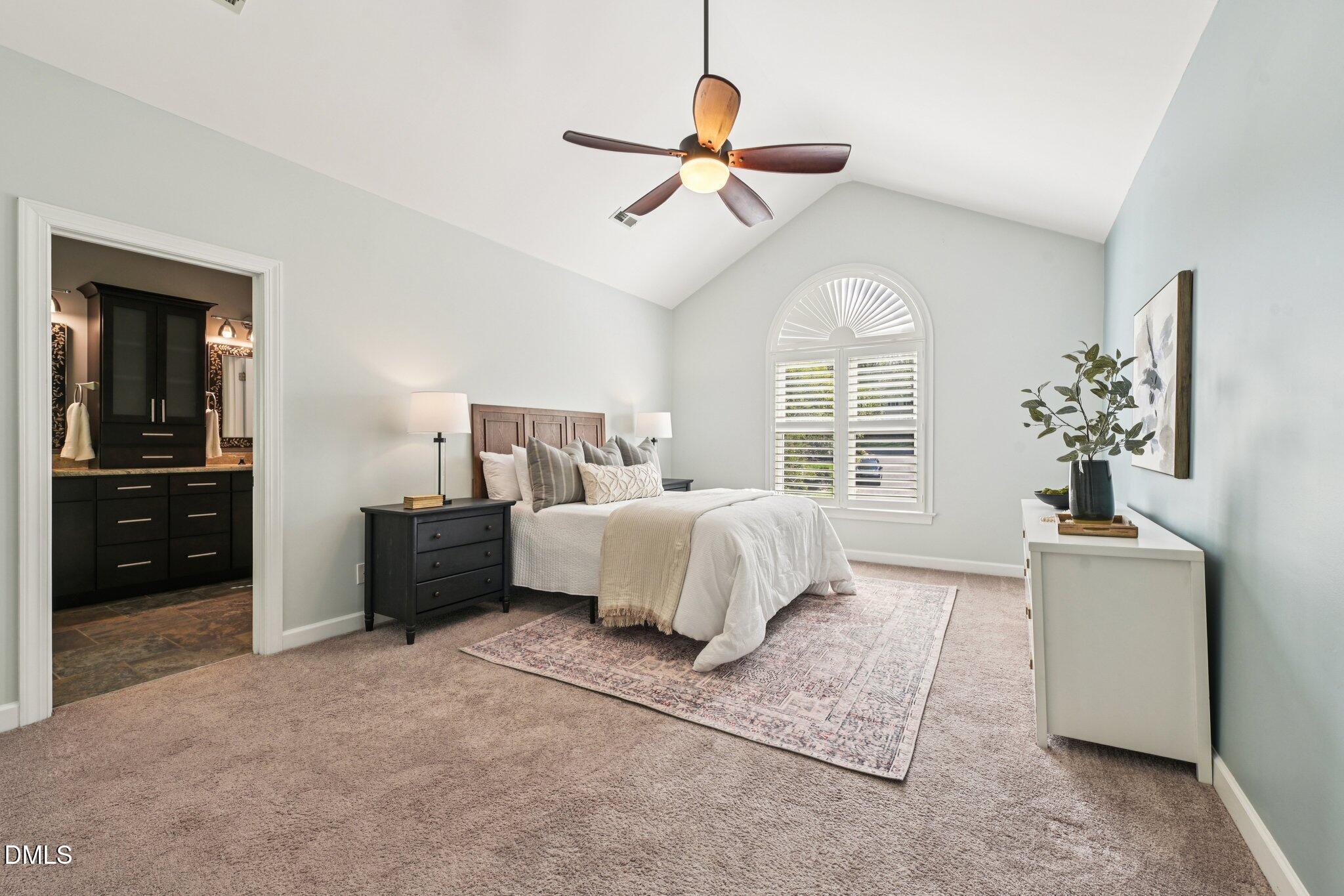 3008 Walton Heath Court Raleigh, NC 27612 - Photo 24 of 57 a spacious bedroom with a bed and a chandelier
