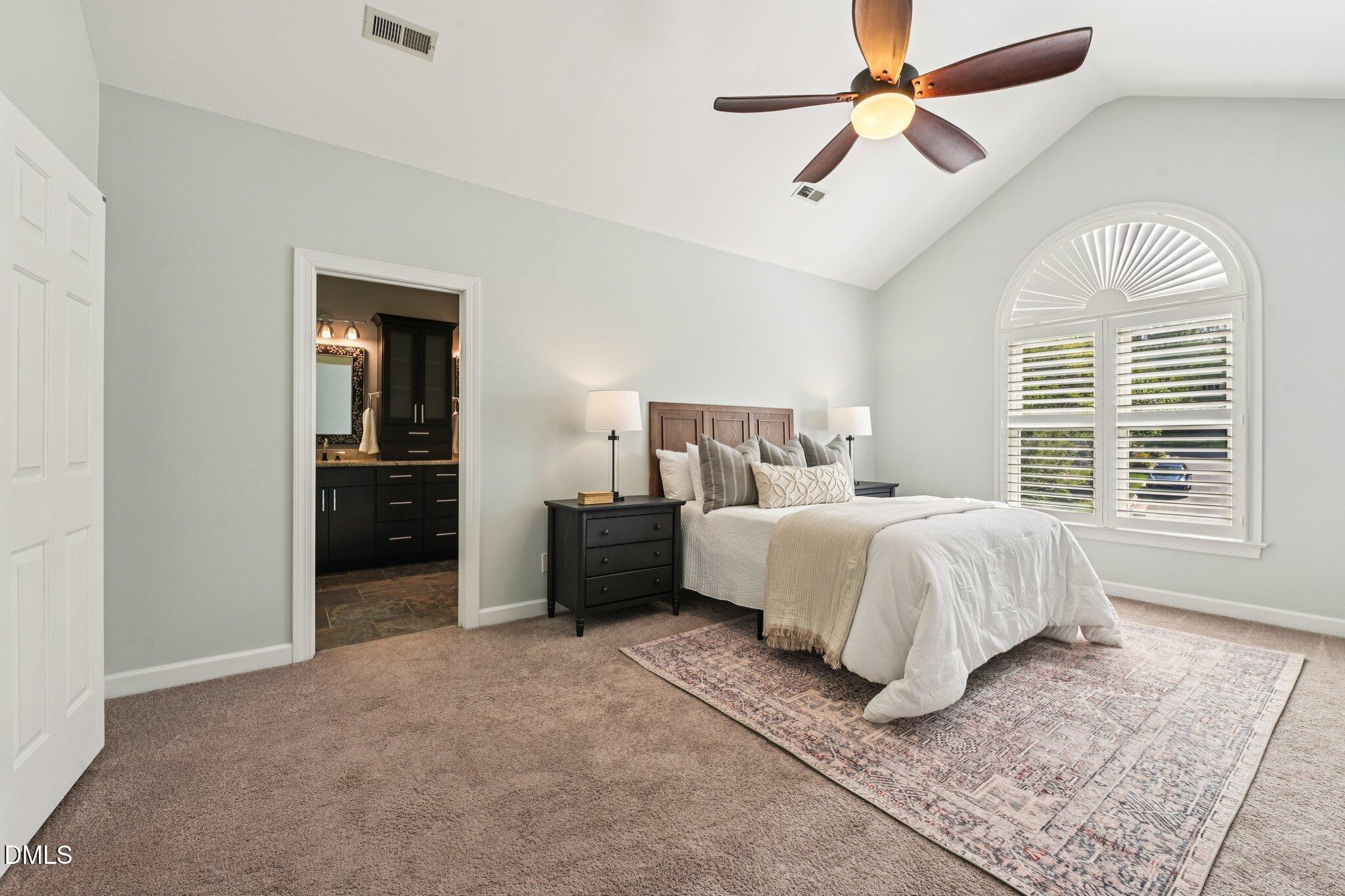 3008 Walton Heath Court Raleigh, NC 27612 - Photo 25 of 57 a bedroom with a bed and a chandelier
