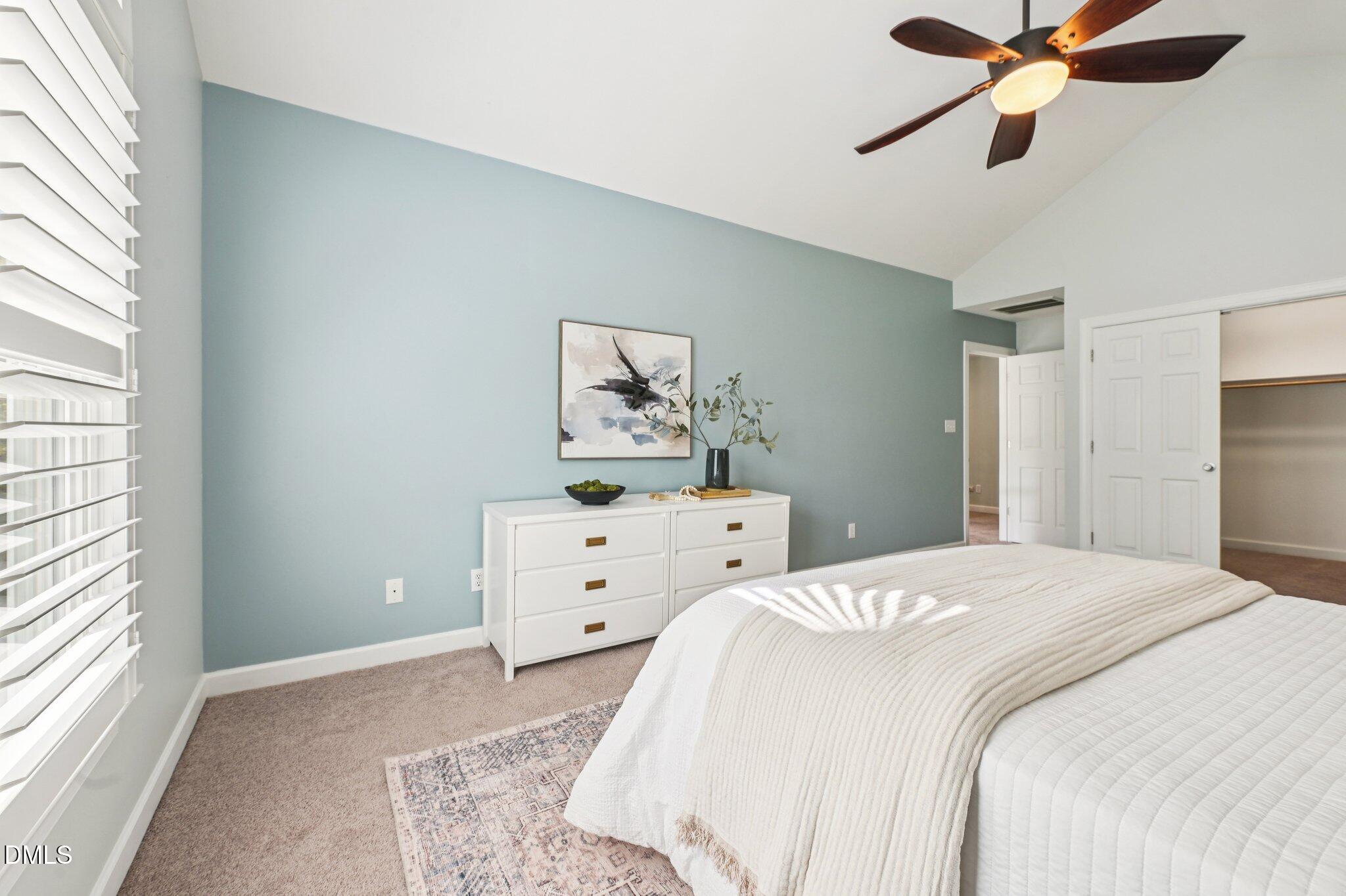3008 Walton Heath Court Raleigh, NC 27612 - Photo 27 of 57 a bedroom with a bed and a chandelier fan