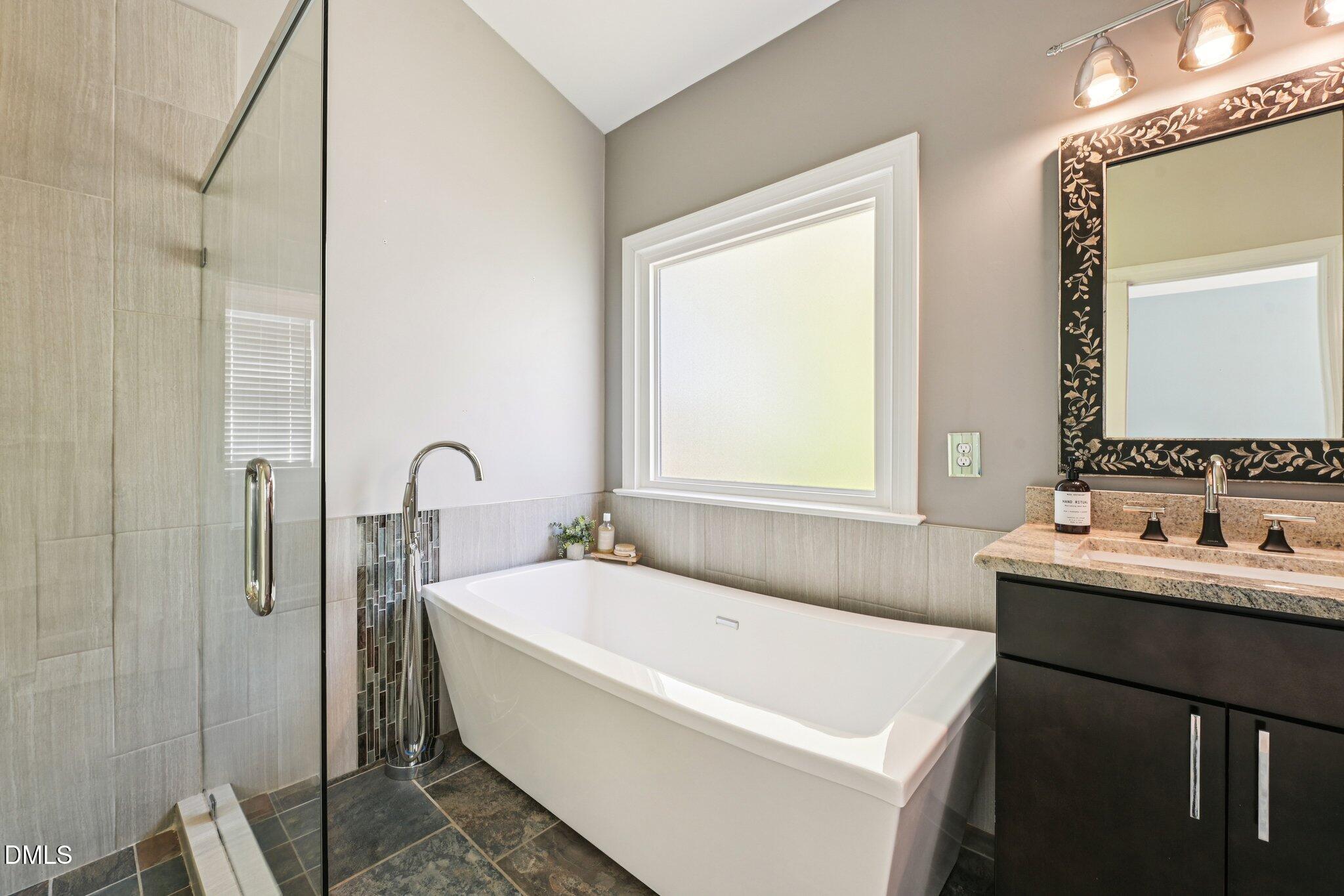 3008 Walton Heath Court Raleigh, NC 27612 - Photo 31 of 57 a bathroom with a bathtub and a sink