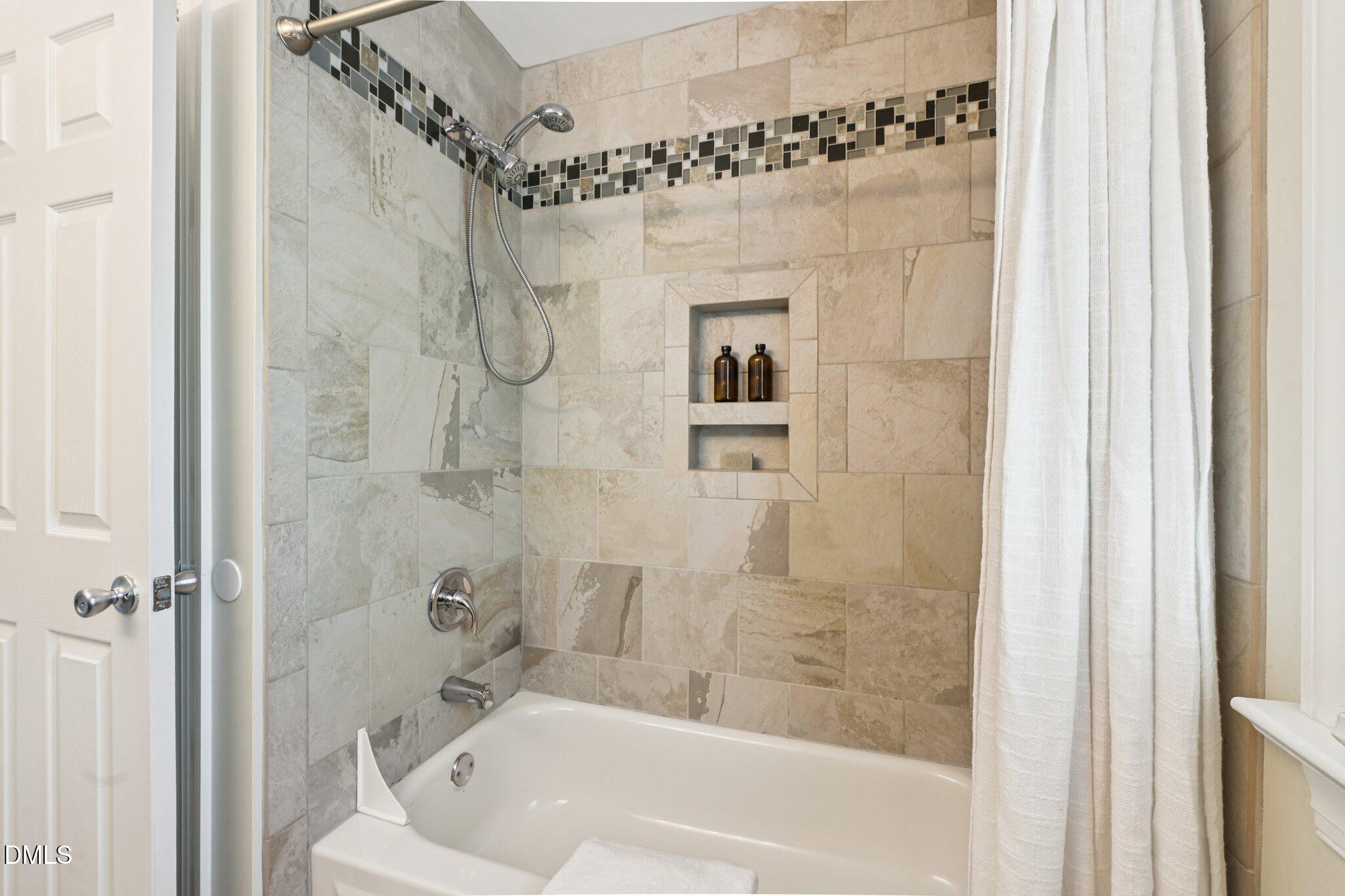 3008 Walton Heath Court Raleigh, NC 27612 - Photo 42 of 57 a bathroom with a shower and a bath tub