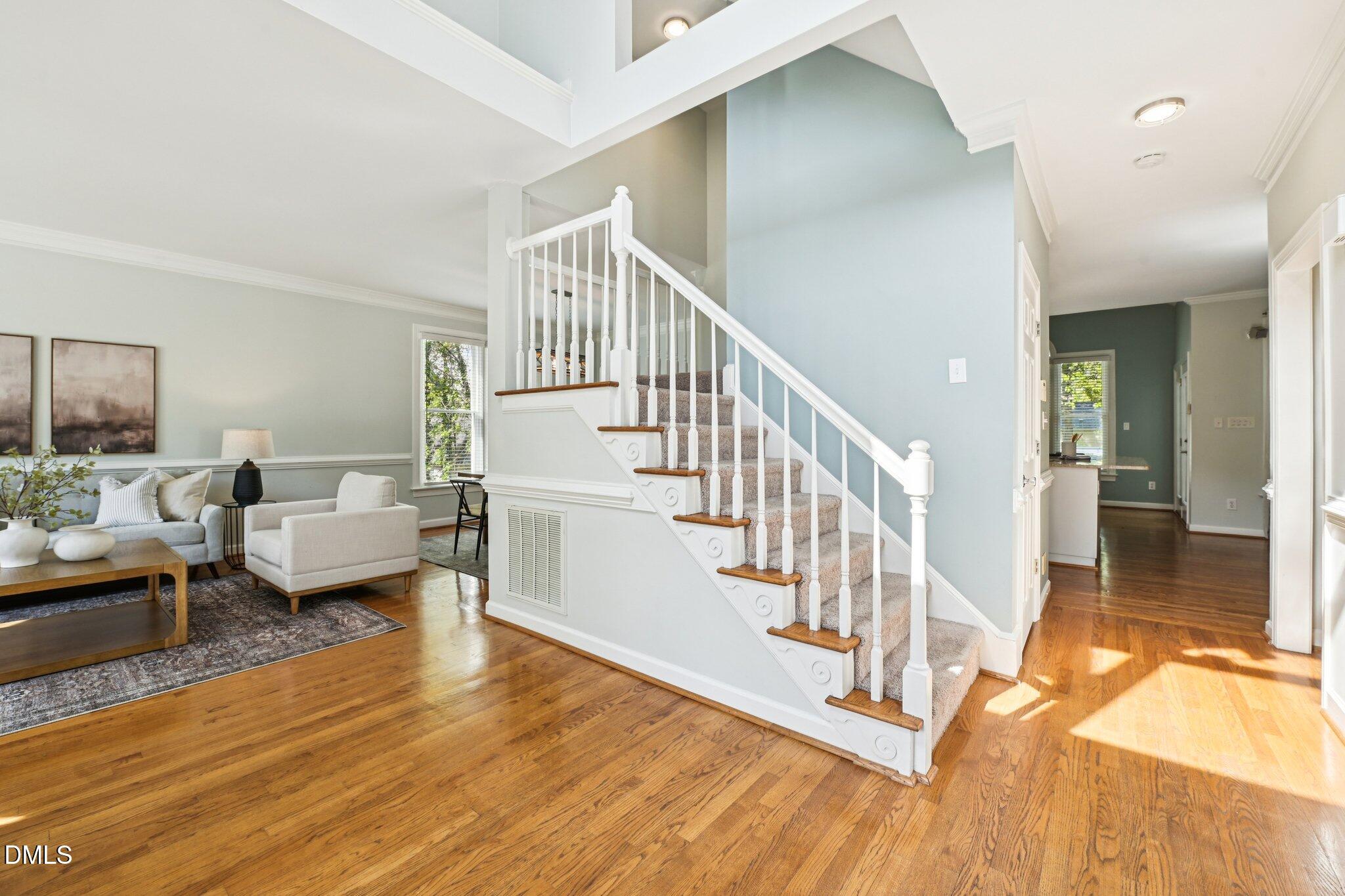 3008 Walton Heath Court Raleigh, NC 27612 - Photo 5 of 57 a living room with furniture and a table with wooden floor