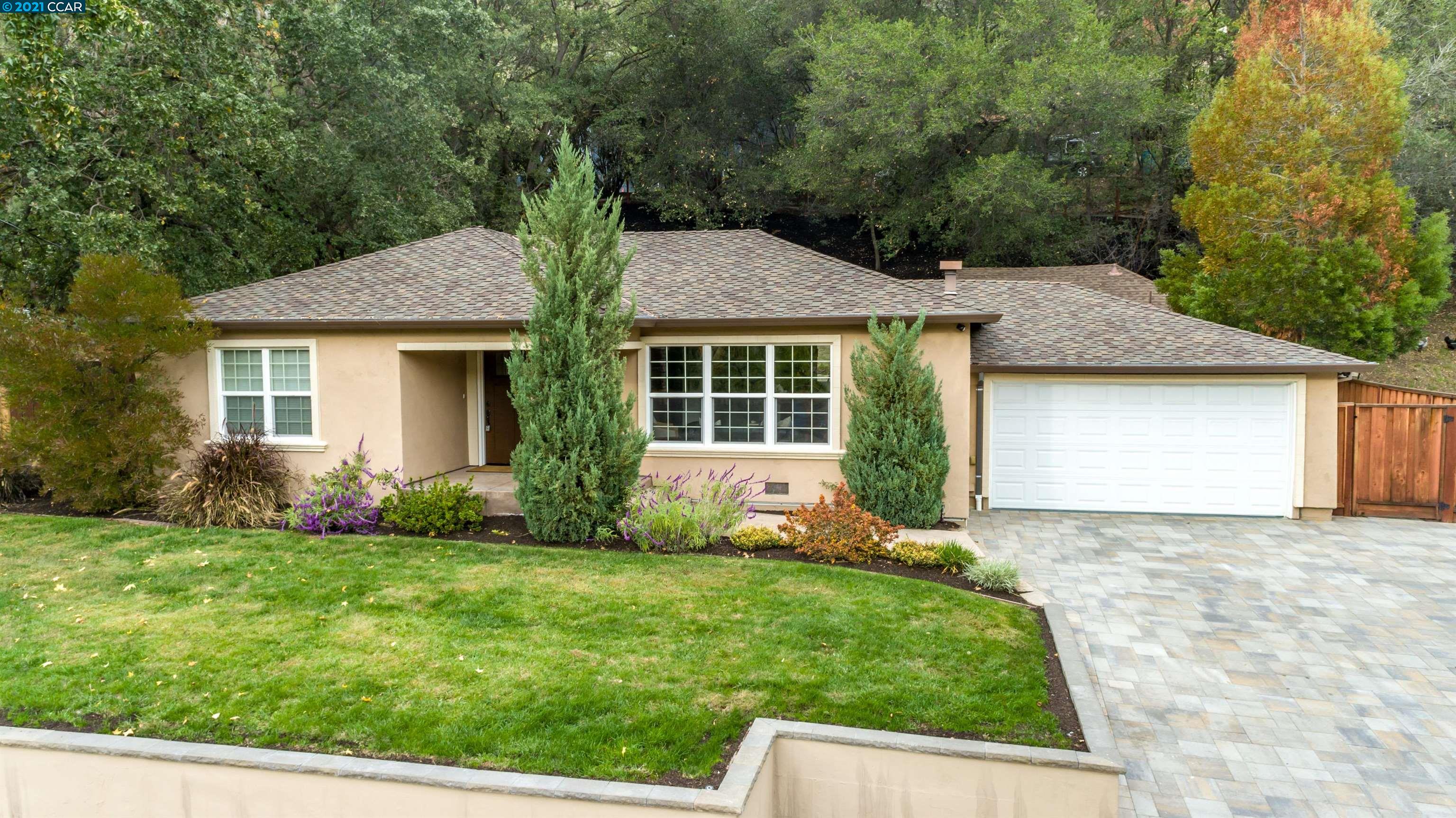a view of a house with a yard and plants