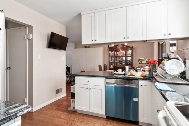 a kitchen with sink refrigerator and window
