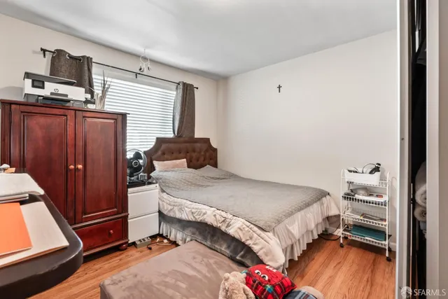 a bedroom with a bed and a chair