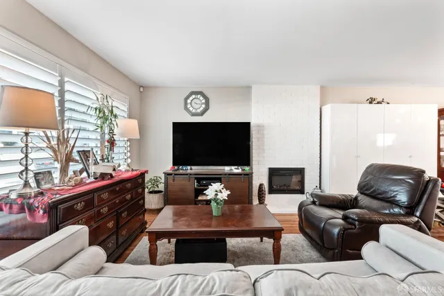 a living room with furniture and a flat screen tv
