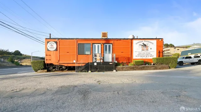 a backyard of a house with outdoor seating
