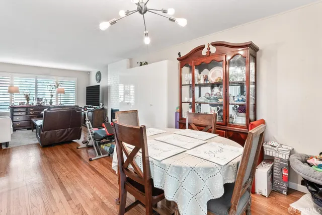 a view of a dining room with furniture window and wooden floor