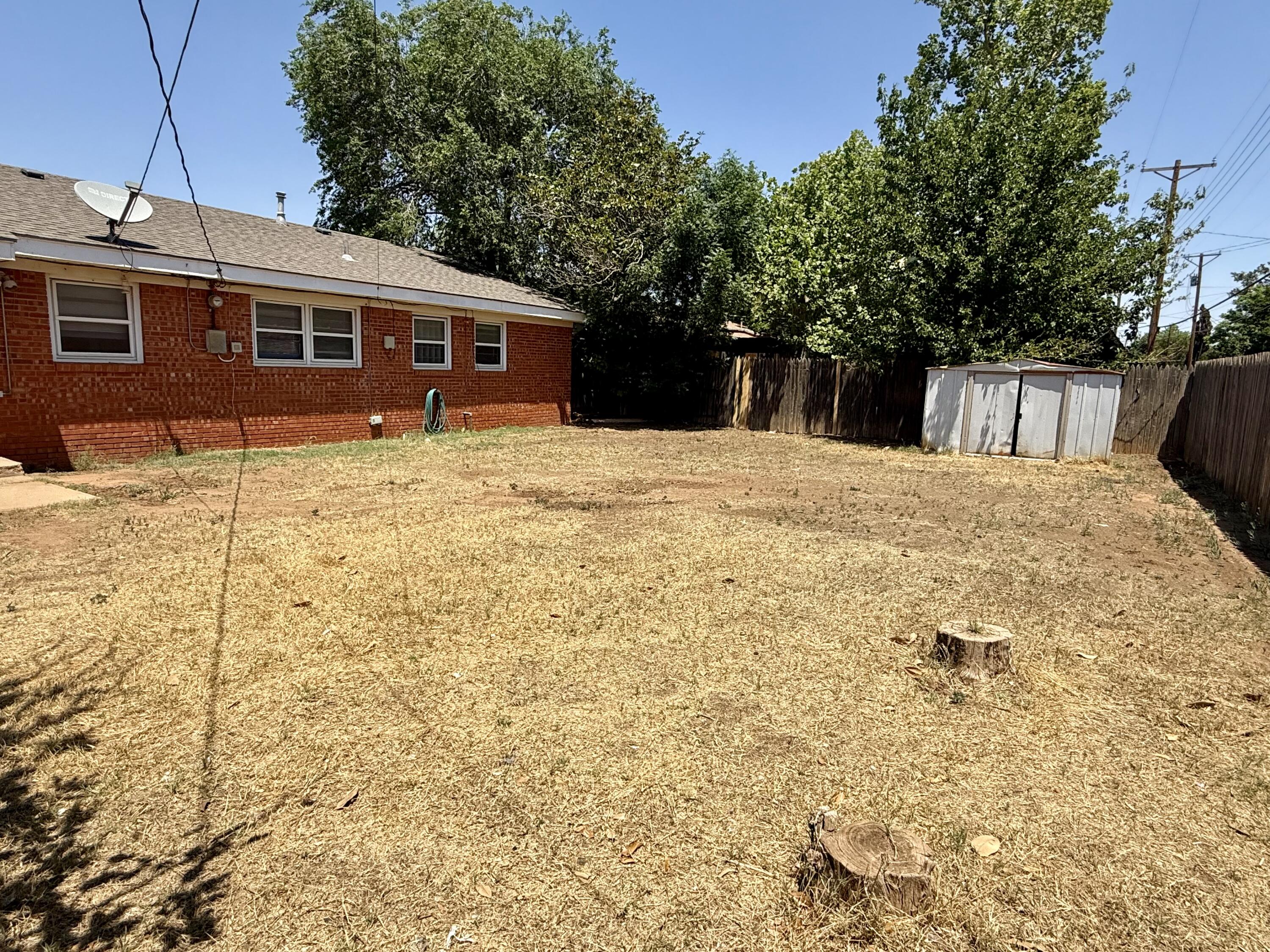2817 63rd Street Lubbock, TX 79413 - Photo 16 of 16 a front view of a house with a yard