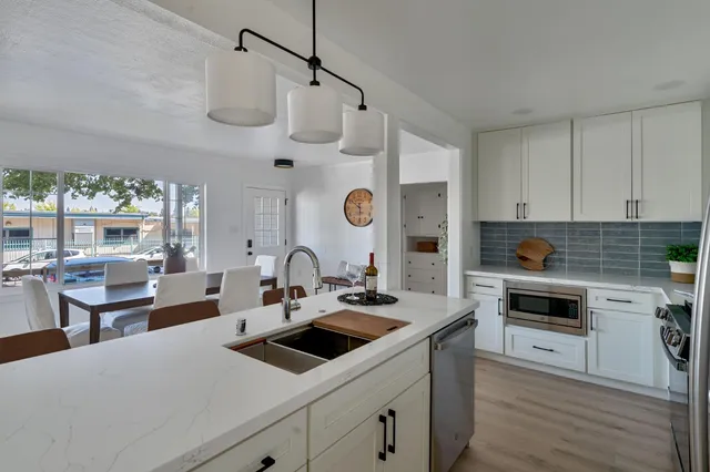 a bedroom with a bed and a view of kitchen