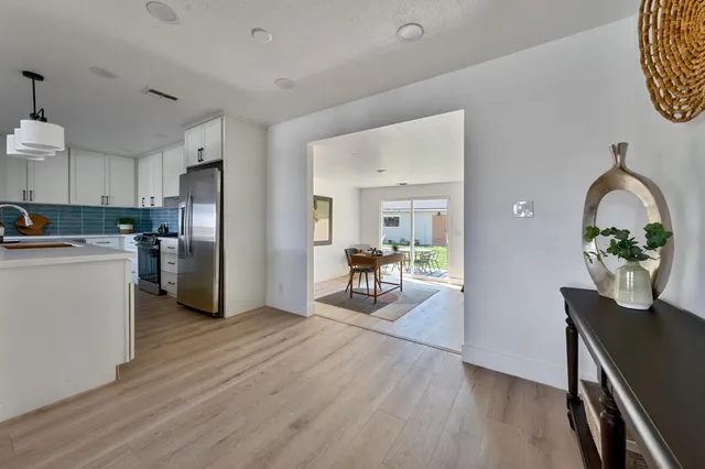 a bathroom with a double vanity sink a toilet a mirror and shower