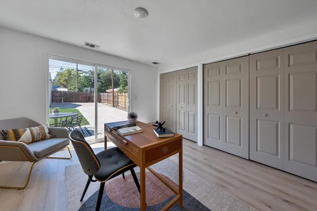 a view of empty room with wooden floor