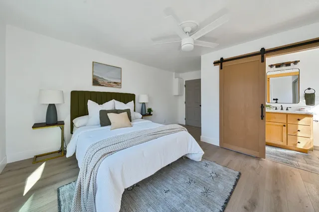 a view of a backyard with plants and table