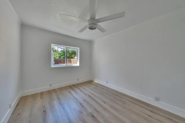 an aerial view of a house with garden space and street view
