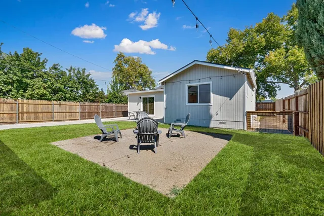 an aerial view of residential houses with outdoor space and city view