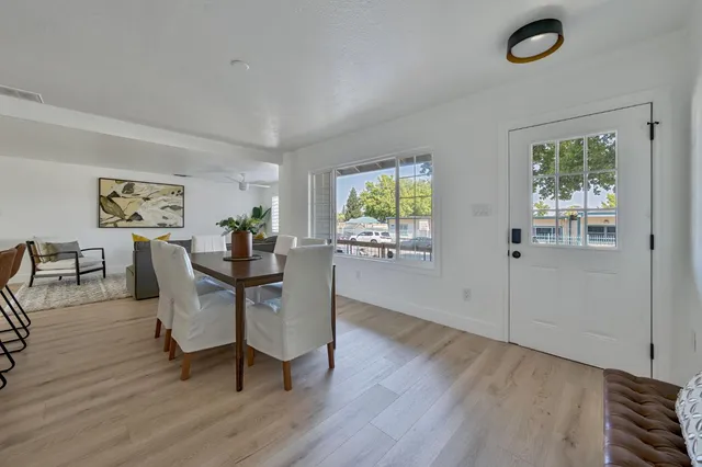 a living room with furniture a rug and a mirror