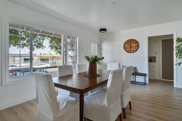 a kitchen with stainless steel appliances a stove a sink and white cabinets