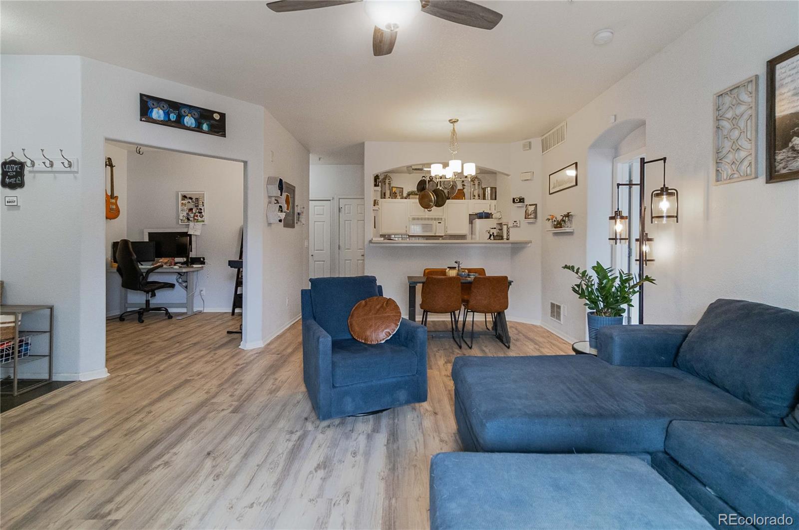 5255 Memphis Street, Unit 702 Denver, CO 80239 - Photo 3 of 30 a living room with furniture dining area and a chandelier