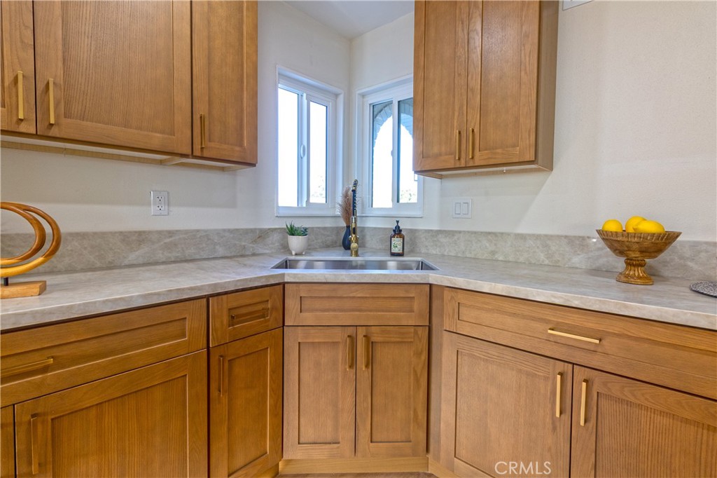 3306 Debbie Lane Riverside, CA 92501 - Photo 12 of 32 a kitchen with stainless steel appliances granite countertop white cabinets and a sink