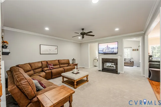 a living room with furniture a fireplace and a flat screen tv