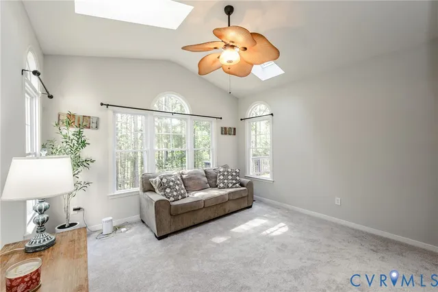 a living room with furniture chandelier and a large window