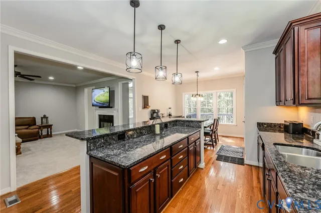 a kitchen with stainless steel appliances granite countertop a stove and a sink