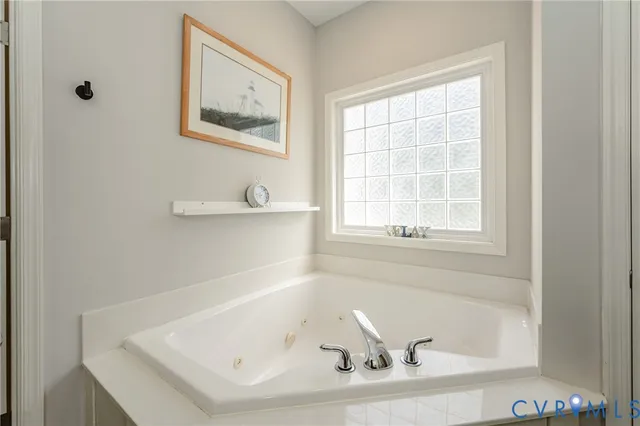 a bathroom with bathtub and window