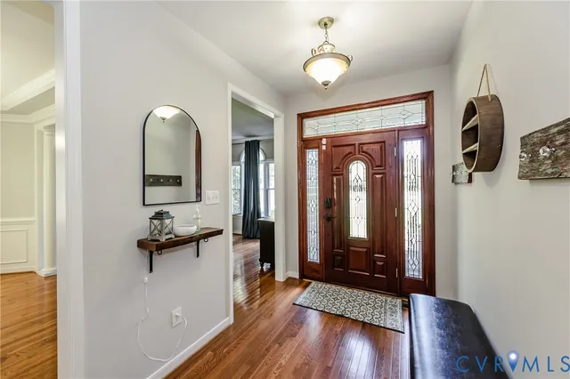 a view of a hallway with wooden floor and windows