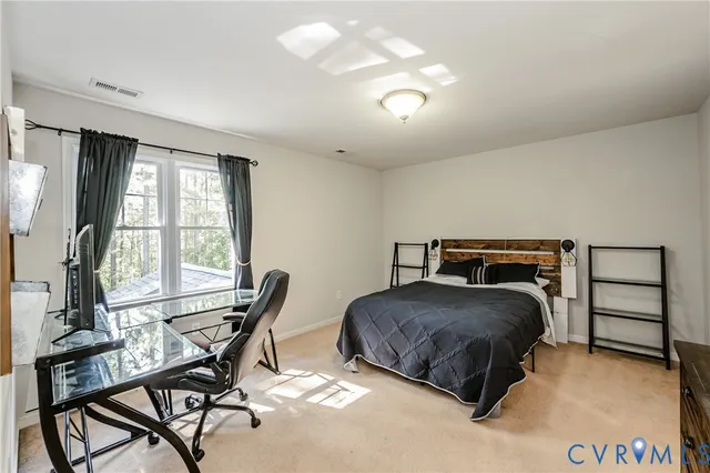 a bedroom with a bed and a table