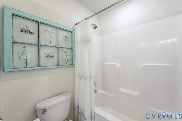 a bathroom with a shower and toilet