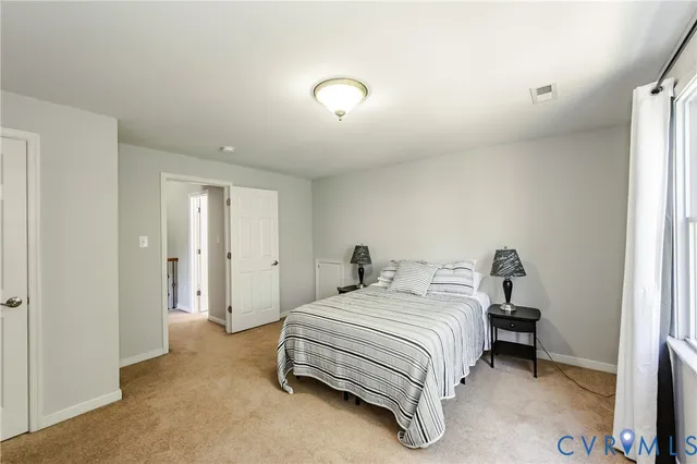 a bedroom with a bed and a lamp