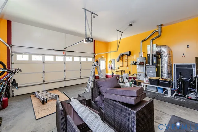 a living room with furniture a flat screen tv and a floor to ceiling window
