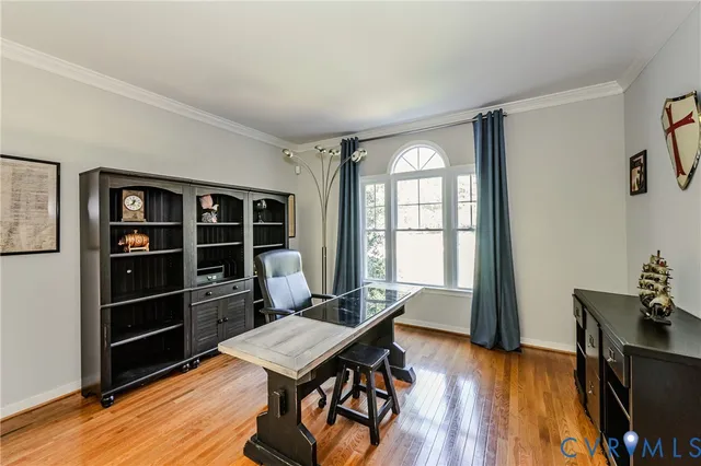 a view of a workspace with furniture and wooden floor