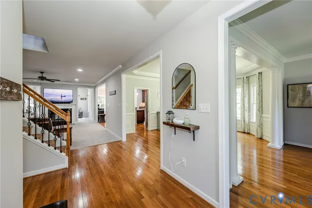 a view of a hallway with wooden floor windows and livingroom
