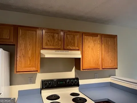 a kitchen with a refrigerator and window