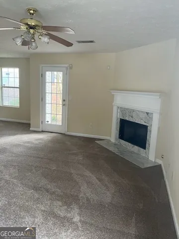 a view of empty room with a fireplace