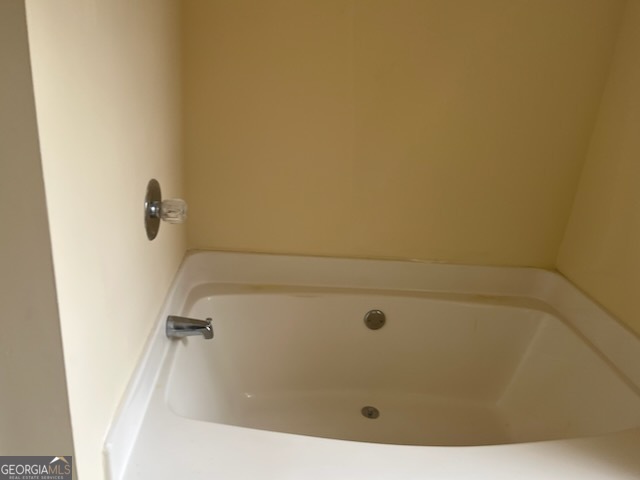 5793 Wind Gate Lane Lithonia, GA 30058 - Photo 7 of 24 a bathroom with a tub