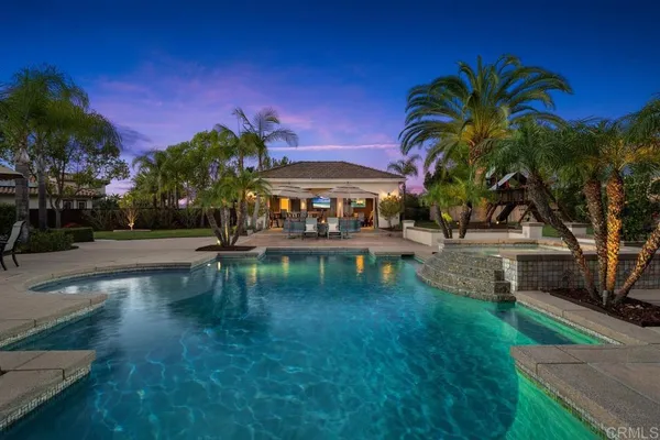a view of a swimming pool with a table and chairs