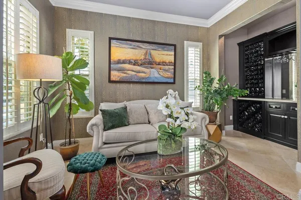 a kitchen with stainless steel appliances kitchen island granite countertop a table chairs and a refrigerator