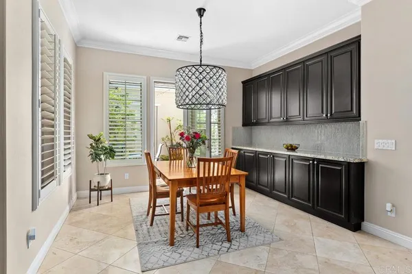 a living room with furniture kitchen and a chandelier