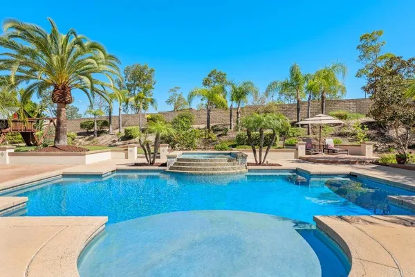 a view of a patio with couches and umbrella