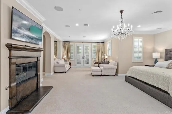 a bedroom with a bed and a large window