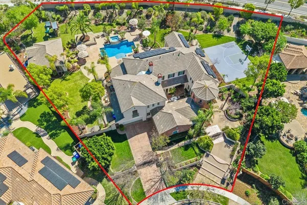 an aerial view of residential houses with outdoor space and street view