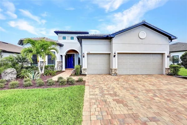a front view of a house with a yard and garage