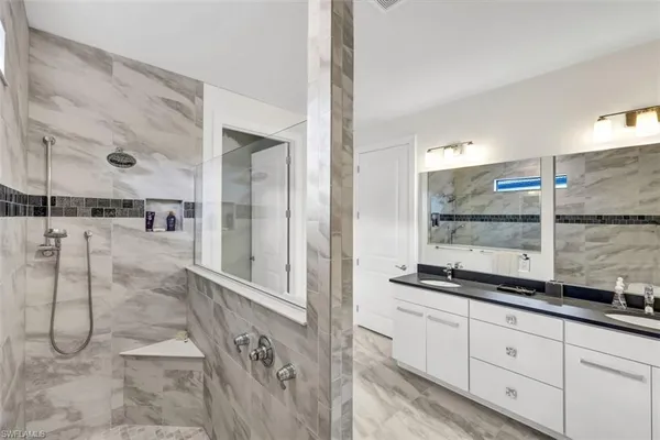 a bathroom with a granite countertop sink mirror and double