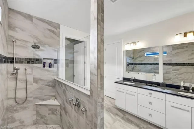a bathroom with a granite countertop sink mirror and double