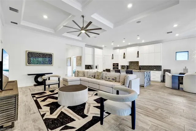 a living room with furniture and kitchen view