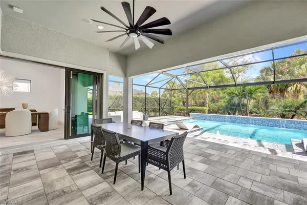a dining room with furniture a rug and a large window