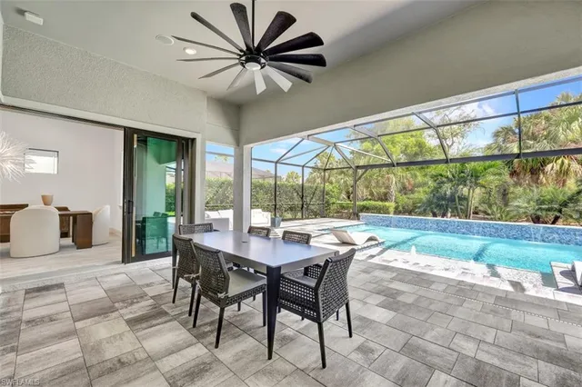 a dining room with furniture a rug and a large window